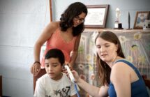 La Conexión at San Josecito in Costa Rica - Two health experts examining a young boy