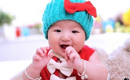Asian Baby girl dressed in bright colors. Appropriate age for DPT vaccine.