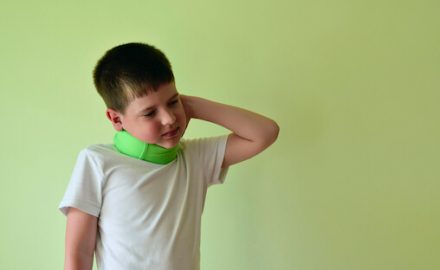 Young boy with a colorful neck brace. Does he have Benign Paroxysmal Torticollis?