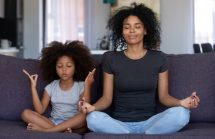 Mother and daughter doing yoga. Sheltering in place during COVID. Supplements, the immune system and preventative care are tools to help families get through it all.