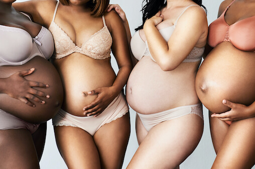 Four pregnant women of different skin colors. Chemical and pregnant women.