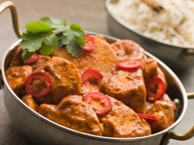 Bowl of tikka masala with rice.