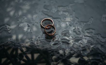 Wedding rings on a black background. Divorce is very painful for everyone involved.