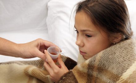 Sick little girl taking medicine from a medicine cup. Dosing Spoon Surprise!
