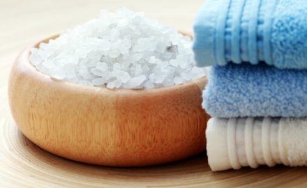 Epsom Salt Bath salt in a wooden bowl with washcloths.