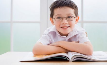 School age boy wearing glasses for his farsightedness.