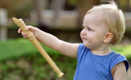 Toddler with a wooden flute. Fomites.