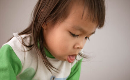 Girl coughing, which leads to droplet transmission