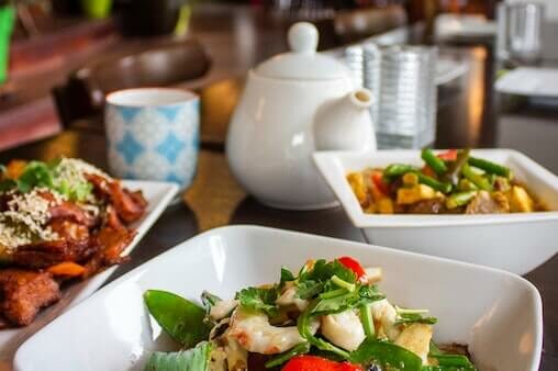 Good nutrition is vital to health. Image of bowls of fresh whole foods and a pot of tea.