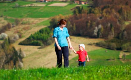 Mother and child walking in a field. Understanding psoriasis.
