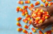 Candy corn in a child's hands. Halloween tricks - Candy isn't a treat!