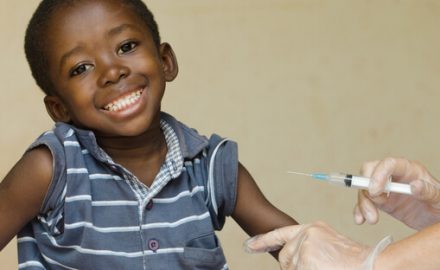 Young African American boy getting a shot. Measles vaccine.