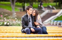 Romantic Teen couple sitting on yellow benches. Must-Know Birth Control Info.