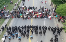 2020 image of police and protestors kneeling during a George Floyd protest.