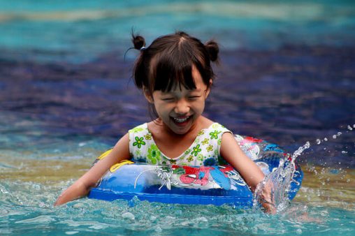 Young Girl Playing in Outdoors Water