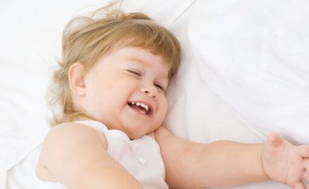 Happy child just before sleep. Will she wake up with sleep terrors?
