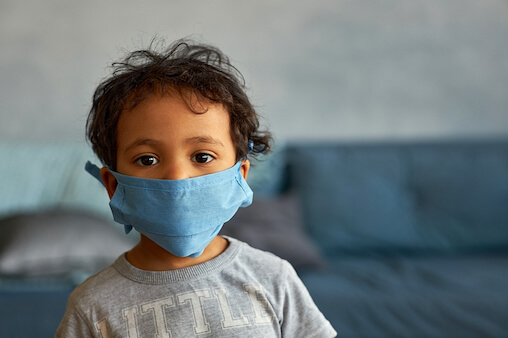 Young boy with face mask. How is social-emotional health of children being impacted by the pandemic?