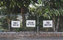 Anti suicide signs on a school fence - stop children committ suicide