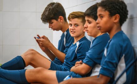 Tween boys in soccer uniforms in a locker room. Tween and teen boys are often concerned about penis size during puberty.
