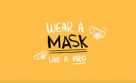 Black lettering on a yellow-gold background -- "wear a mask like a pro".