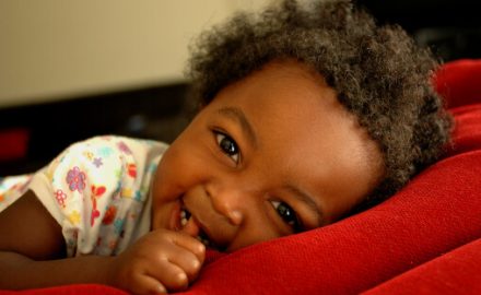 Adorable black child. A high percentage of dark skinned children have Mongolian spots.
