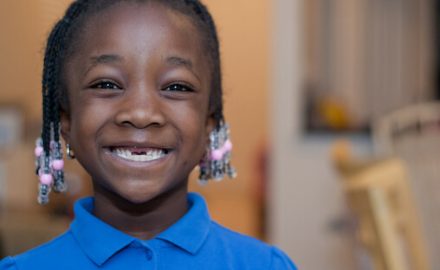 Smiling African American girls with missing front teeth. What to do about cord blood banking.