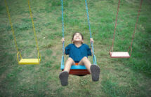 Asian child on a swing. covid bivalent booster children