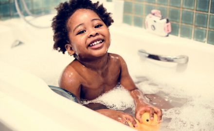 African American child in a bubble bath. How often should children bathe?